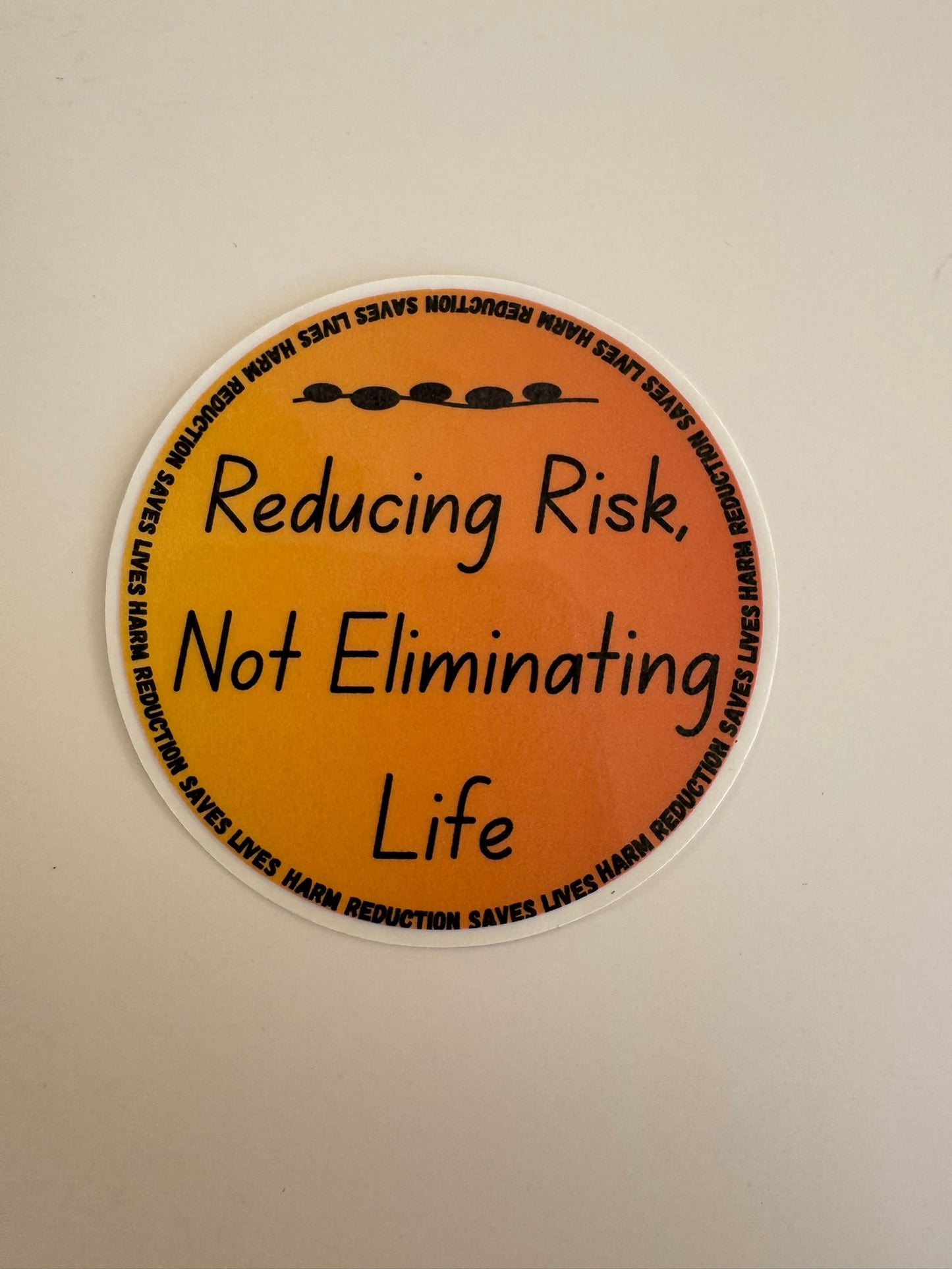 Reducing Risk, Not Eliminating Life Sticker - Circle (Orange Gradient)